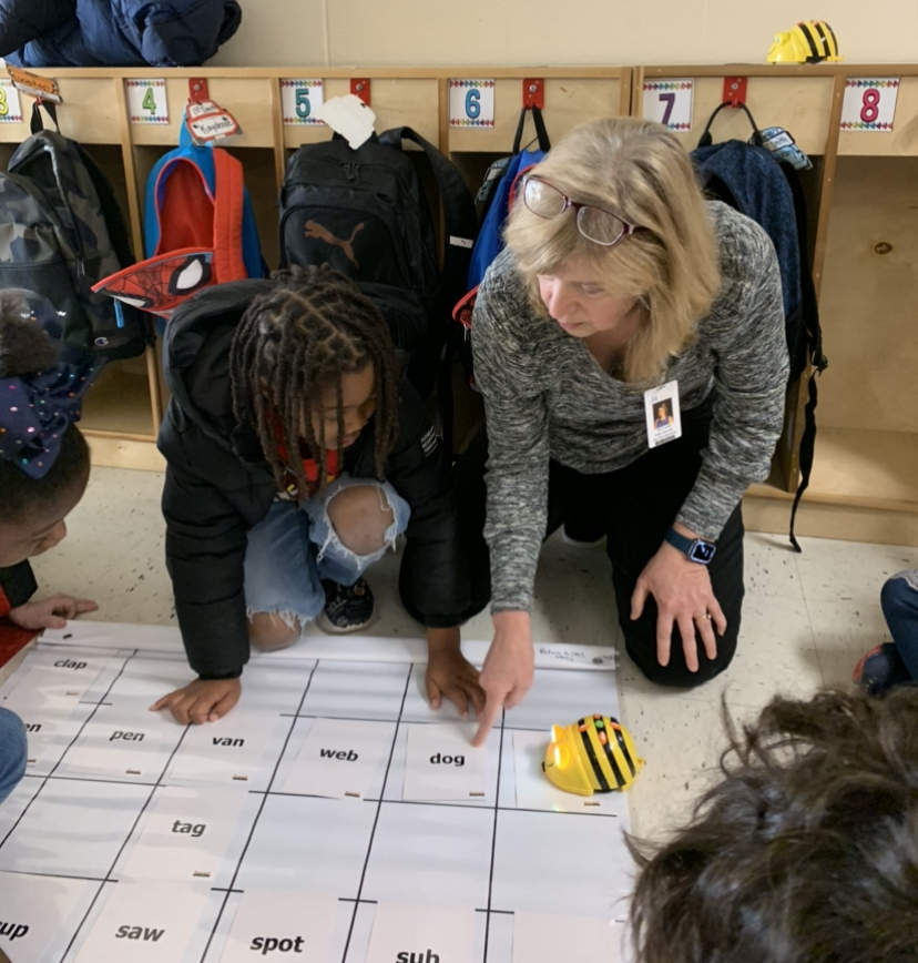 Student and Teacher using BeeBot on a mat with CVC words