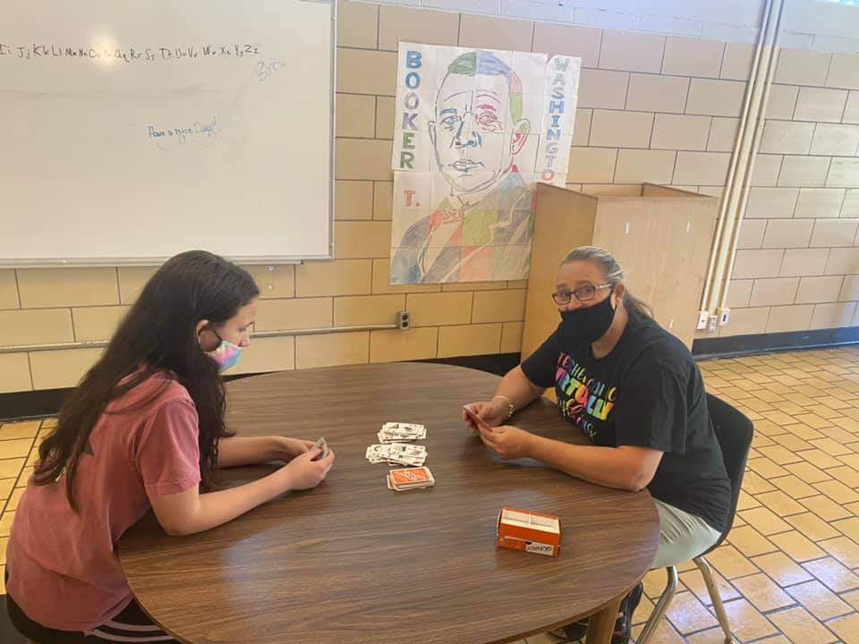 Student and teacher playing board games