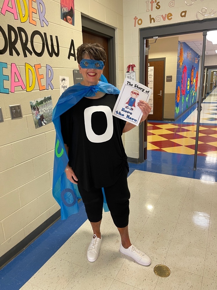 person dressed in blue cape with a shirt with the number 0 on it