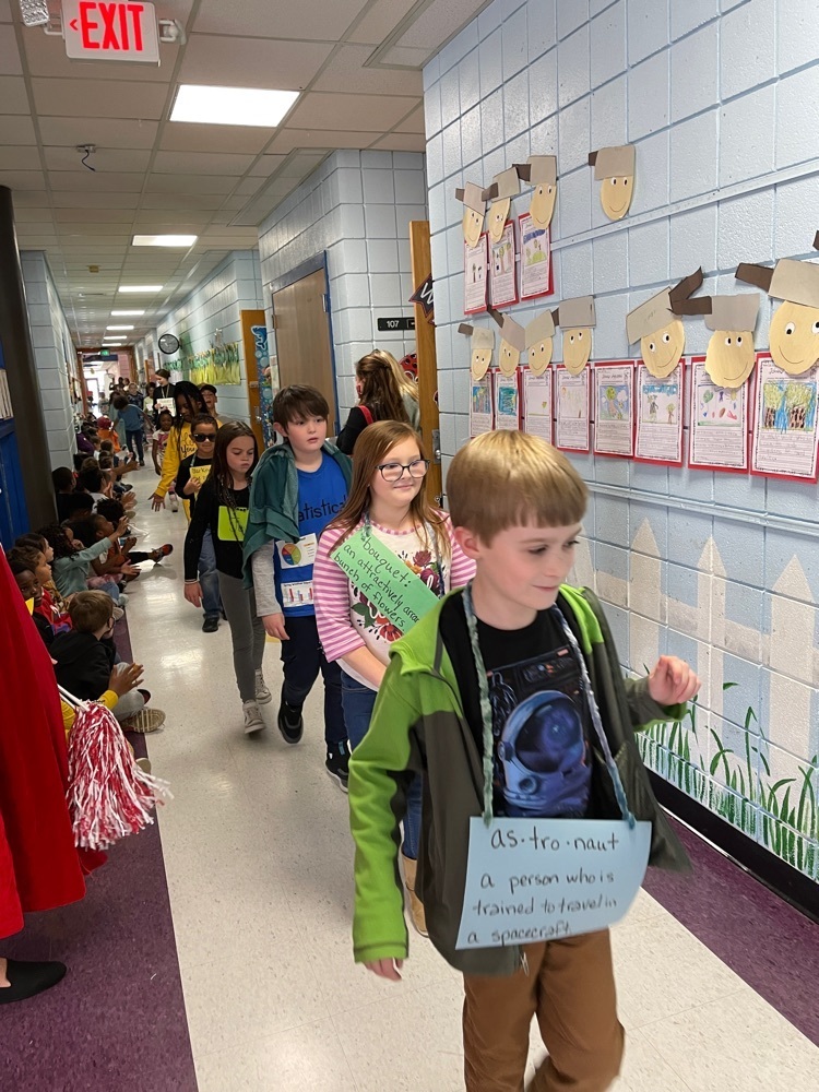 Vocabulary Parade students walking down the hall with other students watching