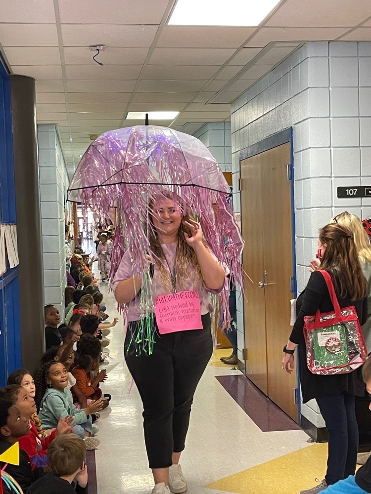 Vocabulary Parade  teacher walking down the hall with students watching